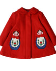 Red wool girls' swing coat with embroidered Matryoshka dolls, satin lining, and hidden button closure