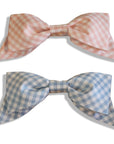 Set of large pink and blue gingham hair bows with secure alligator clips, handmade for girls.
