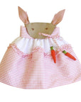 Pink gingham bunny dress with embroidered face, floppy ears, and soft carrot accents. Twirl-worthy skirt with ruffle detail