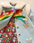 Close-up of Rainbow wool coat, showcasing the soft faux fur collar, vibrant rainbow appliqués, metallic butterflies, and colorful rainbow-print lining