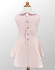 Back view of Little Goodall Blush Linen Scooter Bunny Dress, featuring elegant button closure and tailored fit
