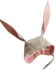 A cozy light grey bunny hat made from Merino wool with soft cuddle fleece lining and velcro chin strap.