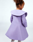 Back view of a purple girls' coat with a wide butterfly-inspired collar, flared silhouette, and soft wool fabric.