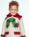 Child wearing a warm wool coat with a Hungry Caterpillar appliqué, red hood with antennae, and functional pockets, designed for toddlers and kids