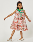 Girl spinning in a sleeveless strawberry dress with a green collar and playful strawberry accents