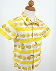 Close-up of boys' lemon print short-sleeve button-up shirt with striped yellow and white design