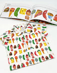 Very Hungry Caterpillar™ Party Food Shirt for toddlers, laid flat beside the matching book, showcasing its colorful food-themed print