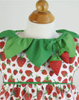 Zoomed-in view of a strawberry-print baby romper with a playful leaf collar and soft strawberry appliqués.