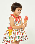 Girl wearing cotton Two Scoops Dress with The Very Hungry Caterpillar print, coral collar, high-low hem, and quilted ice cream cone pockets.