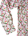 Close-up of pink dog print shirt sleeve with buttoned cuff, cotton sateen fabric