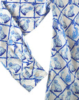 Close-up of the Willa Heart blue and white dog print shirt’s cuff and button details, highlighting the soft cotton sateen fabric and elegant design.