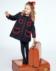 Chic wool winter coat in dark blue with red trim. Classic double-breasted style for girls