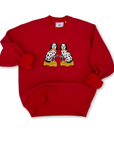 Red sweatshirt with an embroidered graphic of two dogs drinking martinis