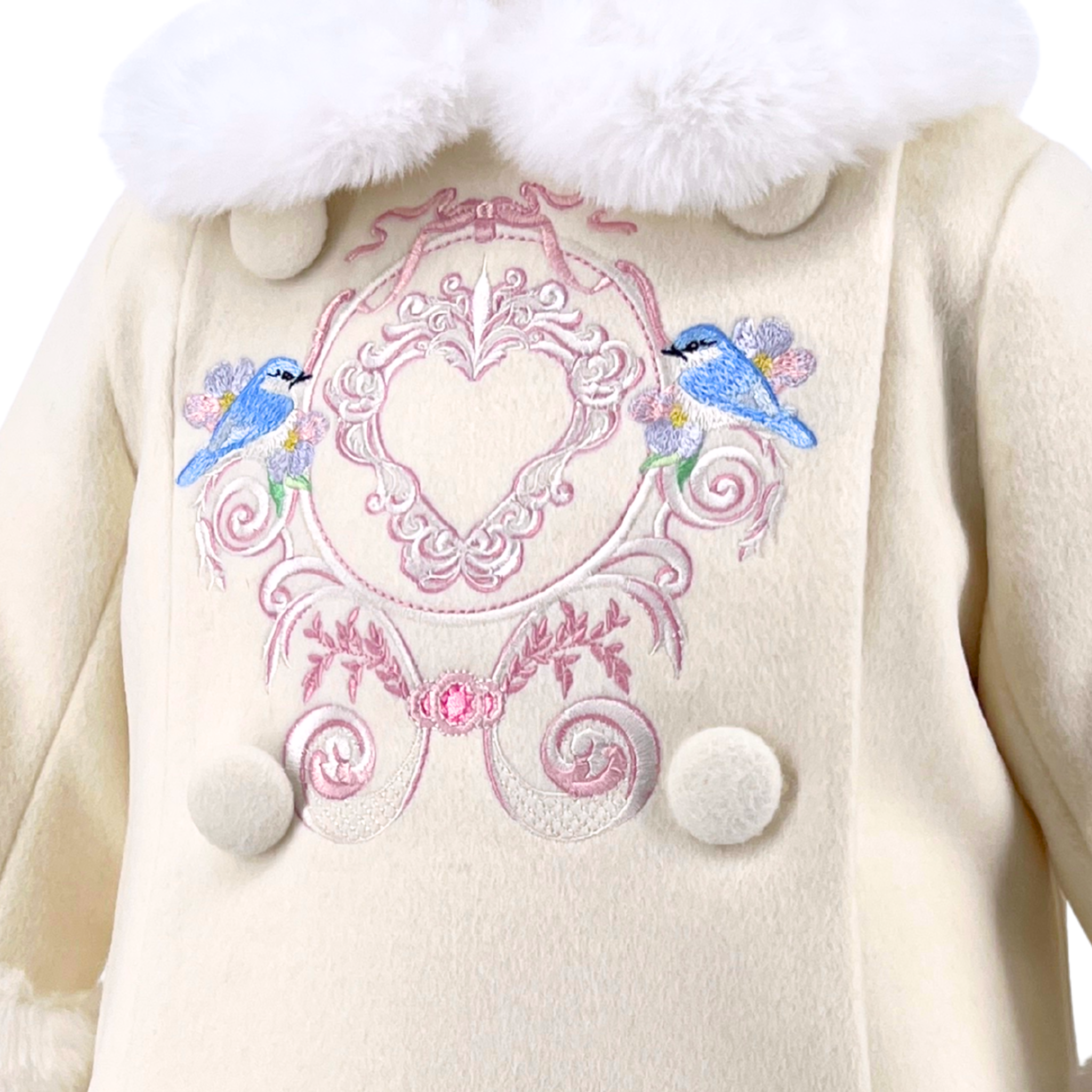 Cream-colored girls coat with decorative pink embroidery and blue birds on a white background