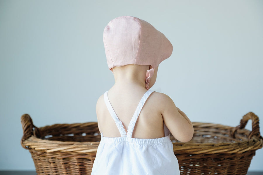 Back of pink bonnet on baby model.