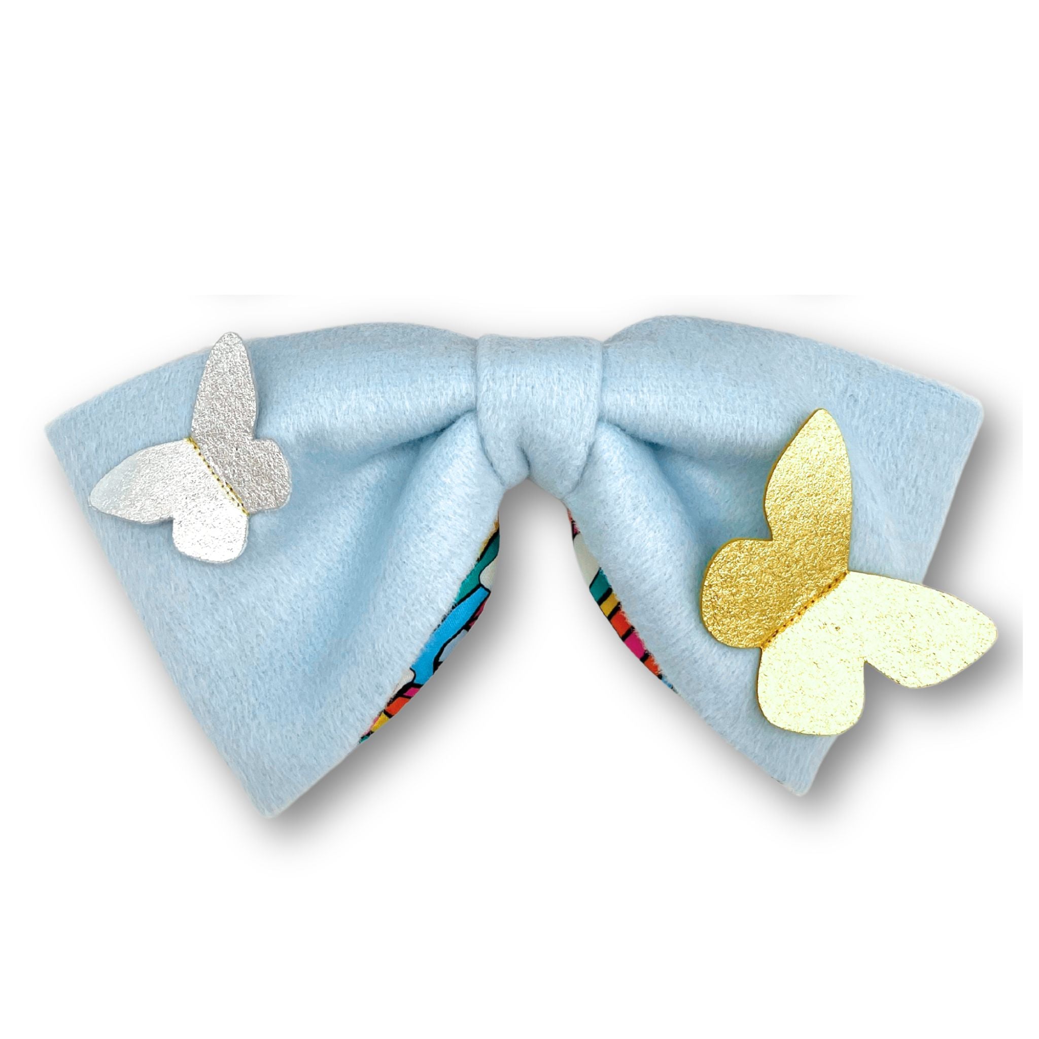 Handmade blue hair bow lined with rainbow satin, featuring metallic butterfly accents and a secure 4-inch French barrette clip