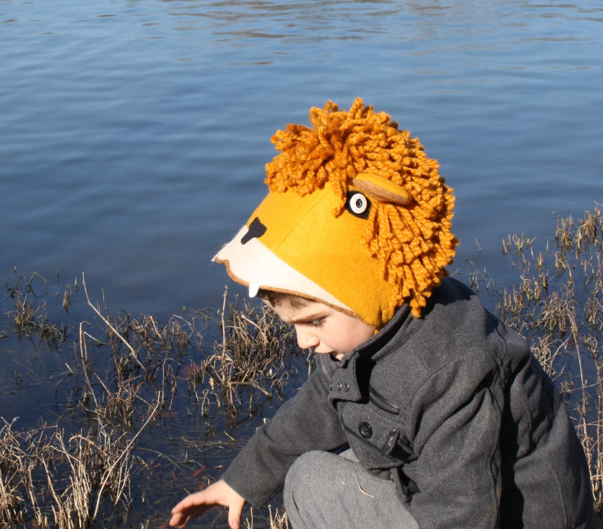 Child wearing a cozy felt lion hat with a sherpa lining and yarn mane, designed for warmth and imaginative play outdoors.