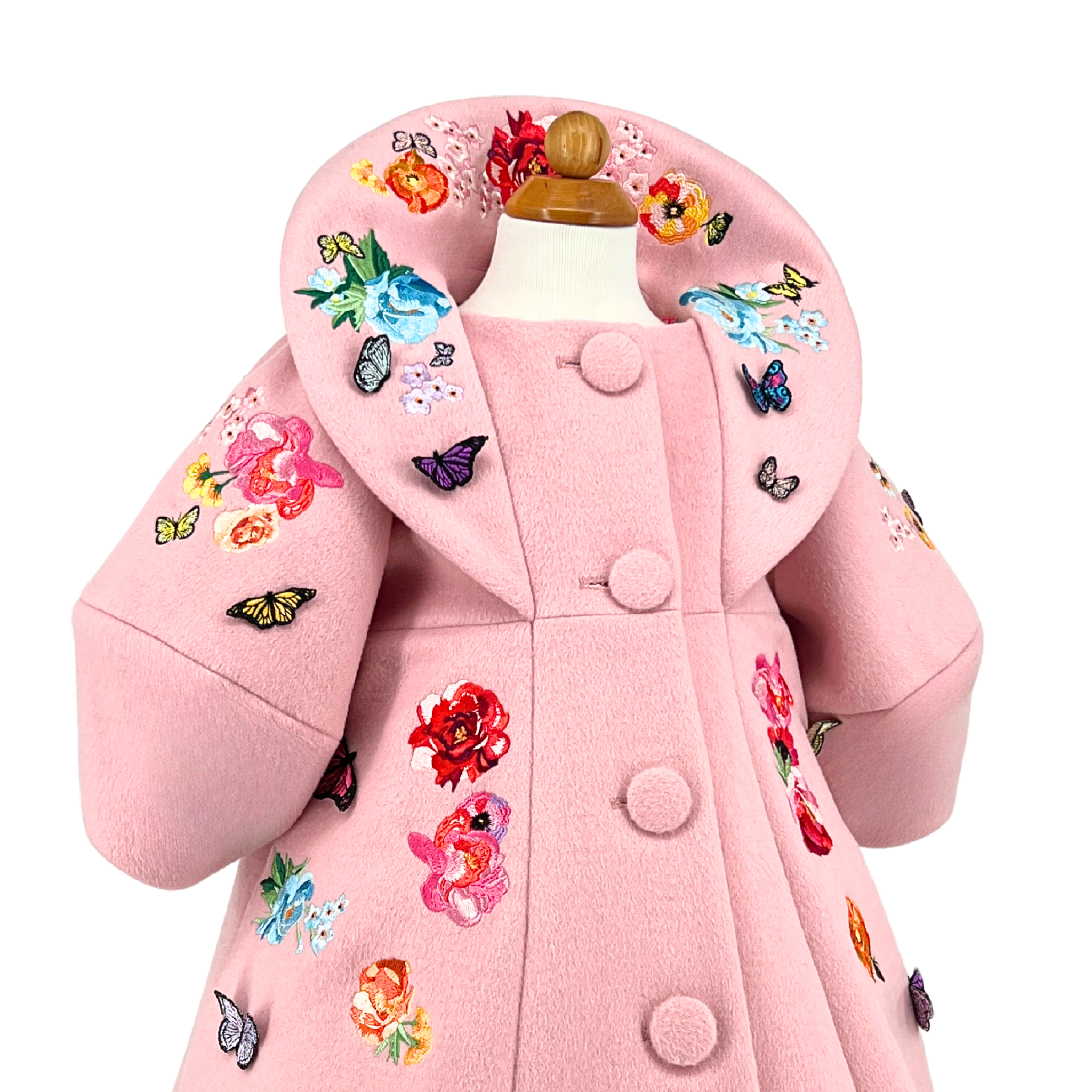 Girls' pink wool coat with Rainbow Bloom floral embroidery and colorful butterfly appliqués, featuring a statement collar and vintage-inspired button detail
