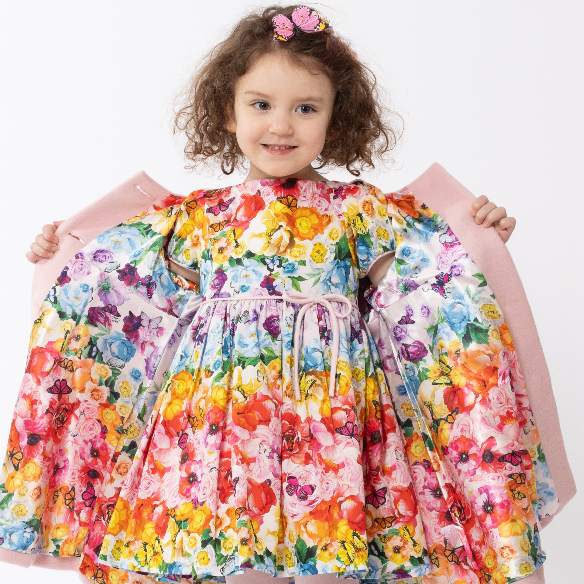 Girls' Rainbow Bloom floral dress with vibrant multicolor flowers and butterfly print, featuring puff sleeves, a waist tie, and a twirl-worthy silhouett