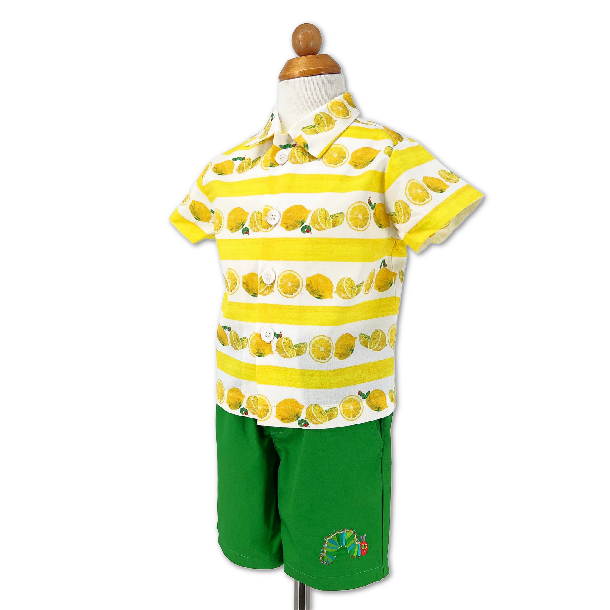 Toddler and kids outfit on form with green shorts and a lemon-striped button-up shirt featuring an embroidered Hungry Caterpillar