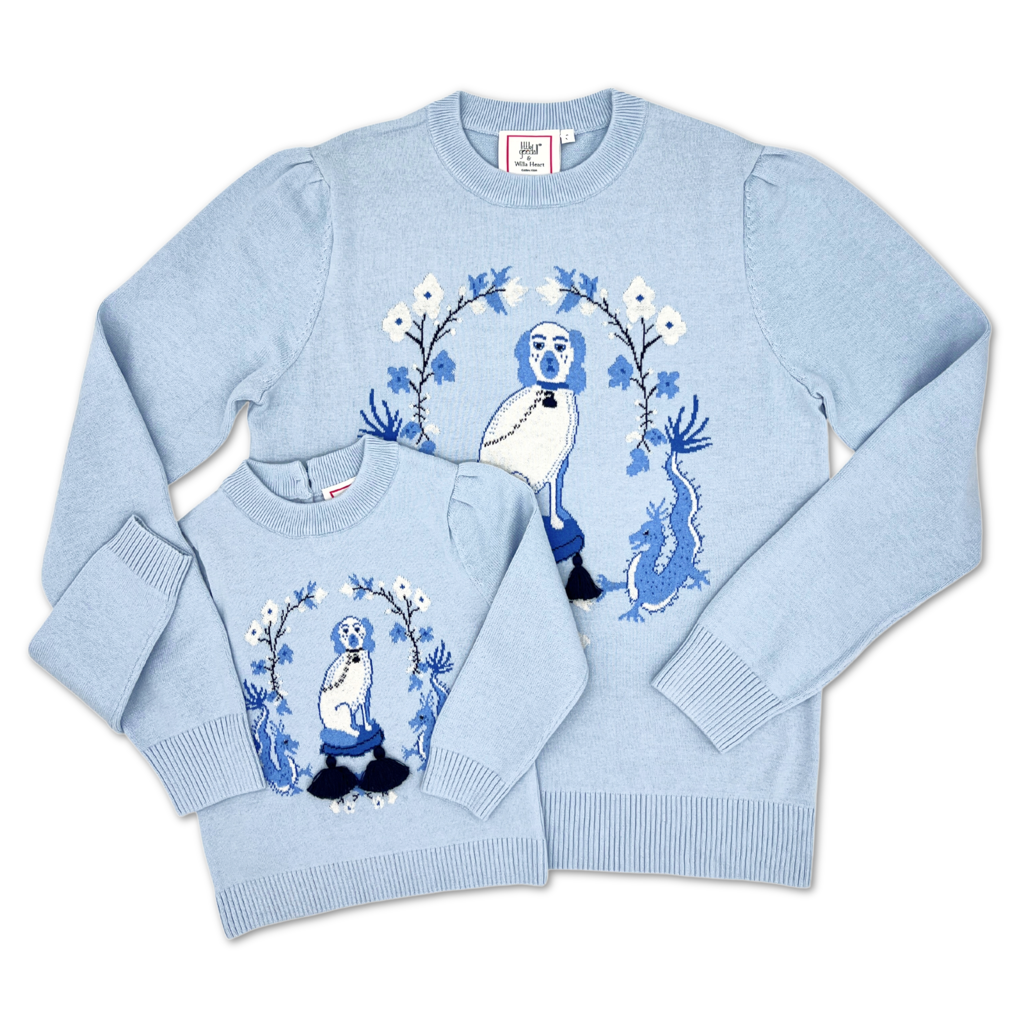 Light blue Kids Willa Heart Sweater with puffed shoulders, showcasing a dragon, bird, and floral knit motif