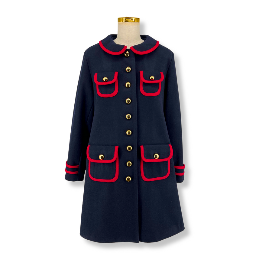 Ladies' deep blue wool coat with bold red trim, gold-tone buttons, and four pockets. A-line design with exclusive Paddington print lining