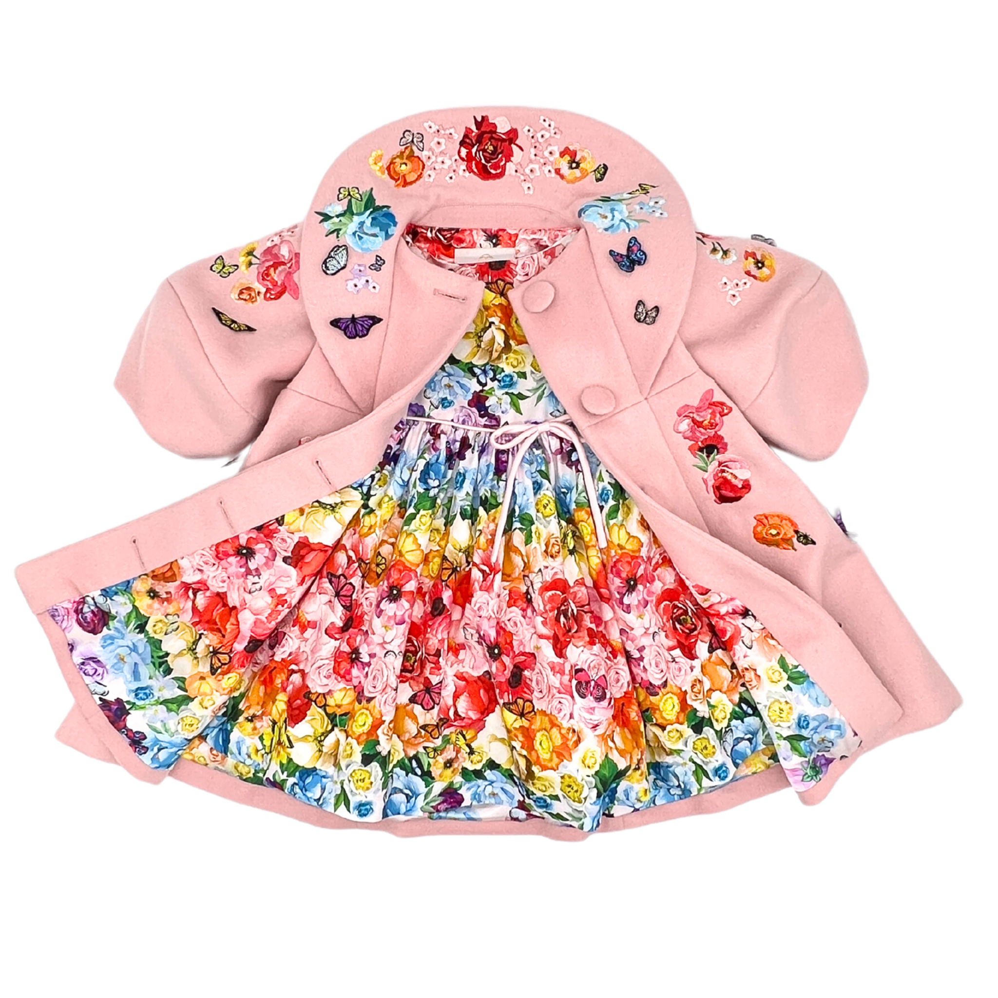 A beautiful pink embroidered coat with floral and butterfly details layered over the Rainbow Bloom Dress, features a vibrant multicolor floral and butterfly print
