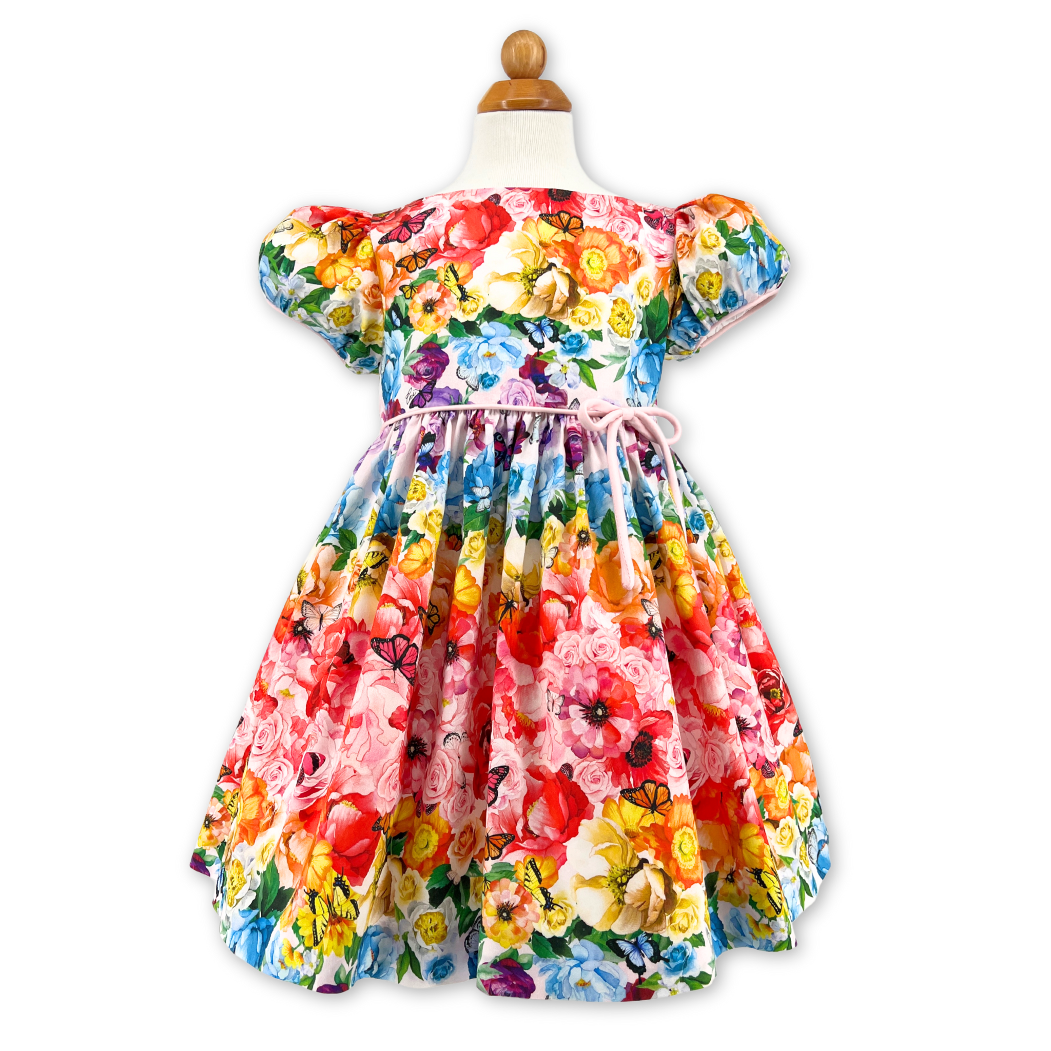 Rainbow Bloom Party Dress with a vibrant floral butterfly print, puff sleeves, pink waist bow, and full skirt, perfect for special occasions