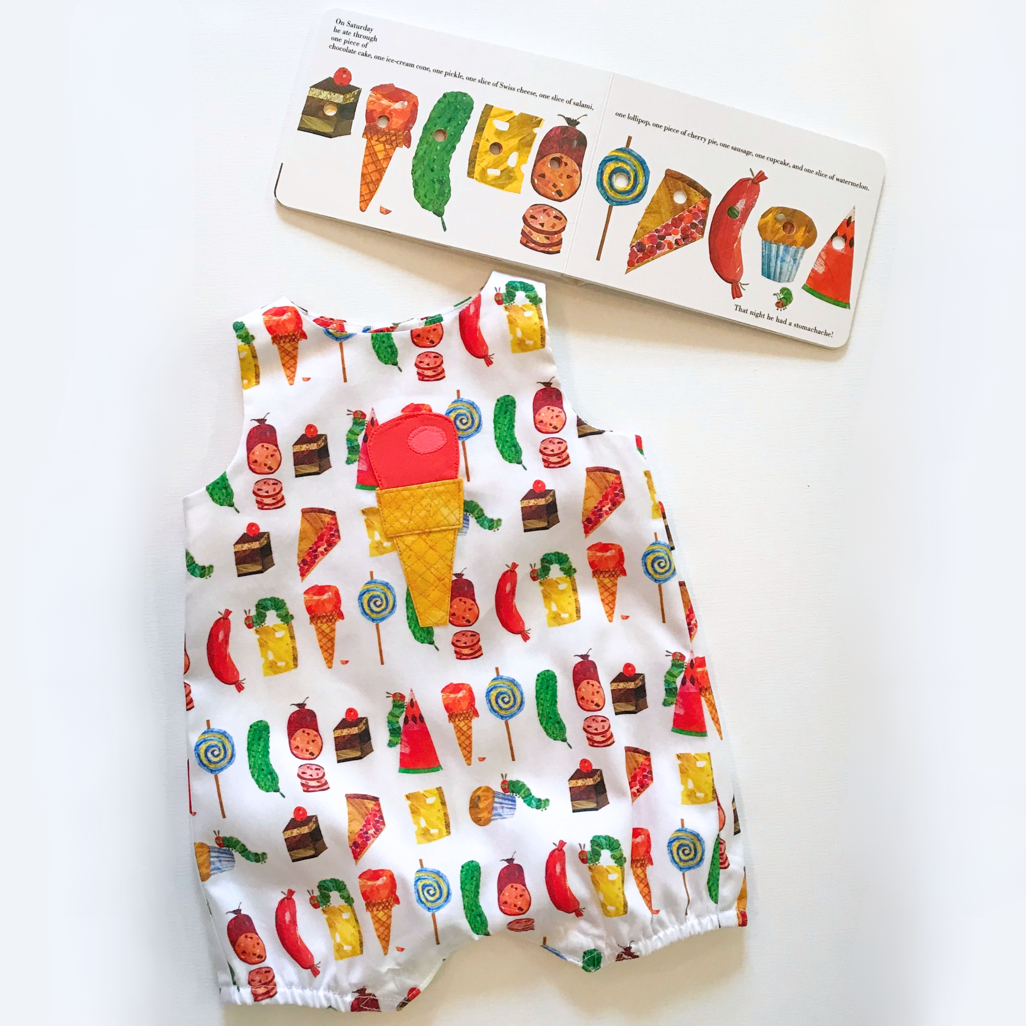 Baby and toddler romper featuring The Very Hungry Caterpillar™ food print with ice cream appliqué, paired with an open book.