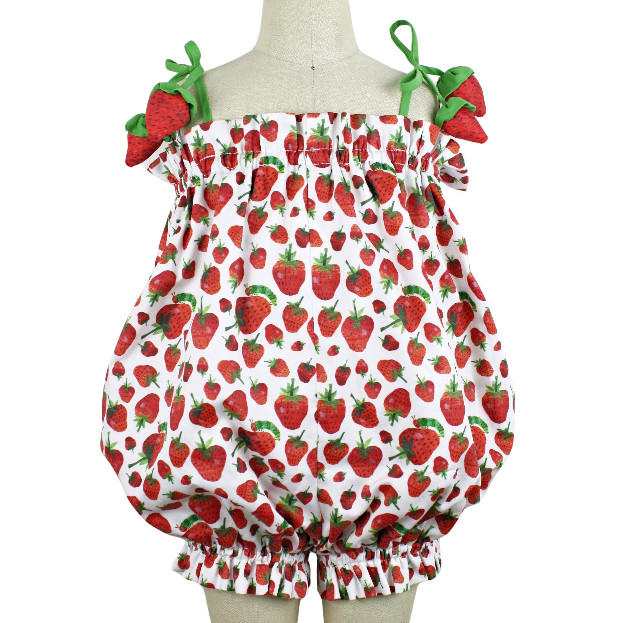 Whimsical strawberry-print baby romper with tie shoulders and ruched elastic trim.