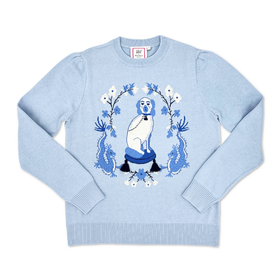 Powder blue Willa Heart dog sweater laid flat, featuring an intarsia knit dog and dragon motif with tassel
