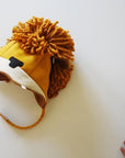 yellow lion hat on table