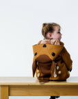 Back view of brown fawn coat on girl model with the hood down, displaying the fawn hood.