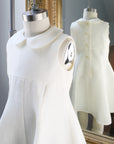 Ivory Linen party dress for girls on a dress form 