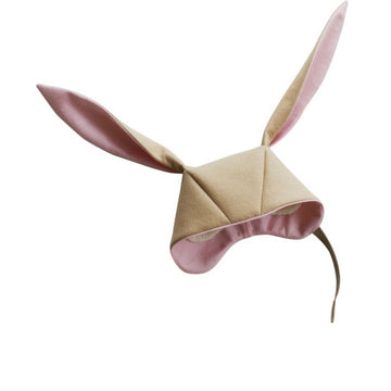 Light tan bunny hat with pink lining within the ears and rim of hood. White hat lining peaking through from inside the hat. 