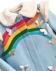 Closeup on the blue coat, displaying the rainbow with different sized butterflies at the end of each color. 