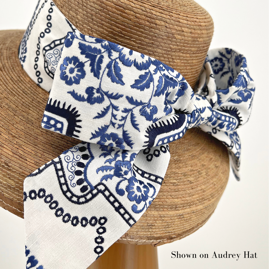 Blue and White Middy Bow Hatband with floral and geometric pattern on a straw hat