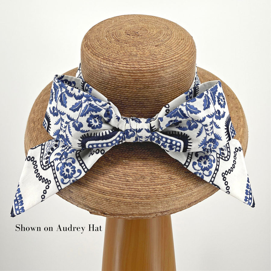 Blue and White Middy Bow Hatband on a straw hat, adjustable with Velcro for mix-and-match versatility.
