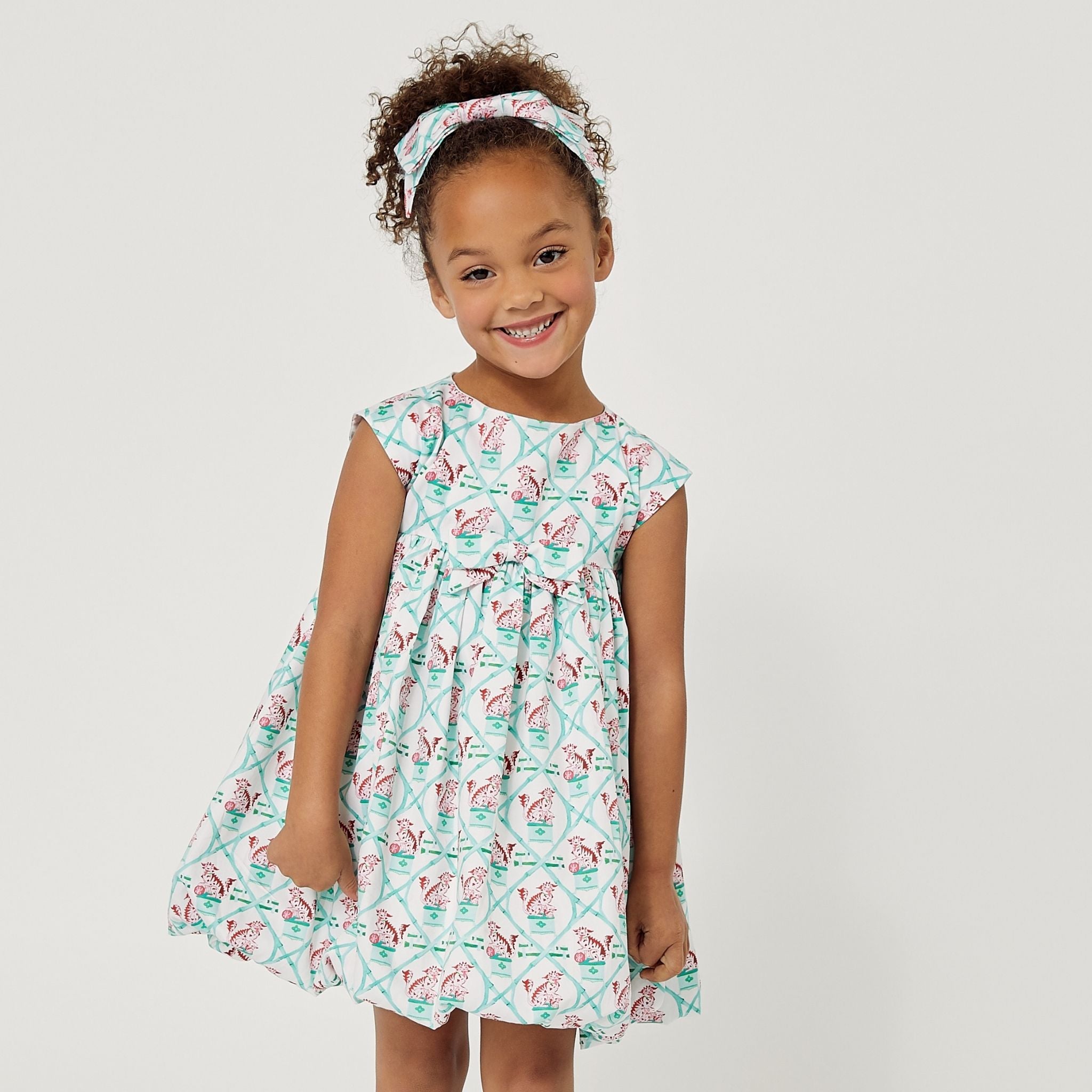Willa Heart Carrot and Dot Dress in mint, styled with a matching headband and bubble skirt