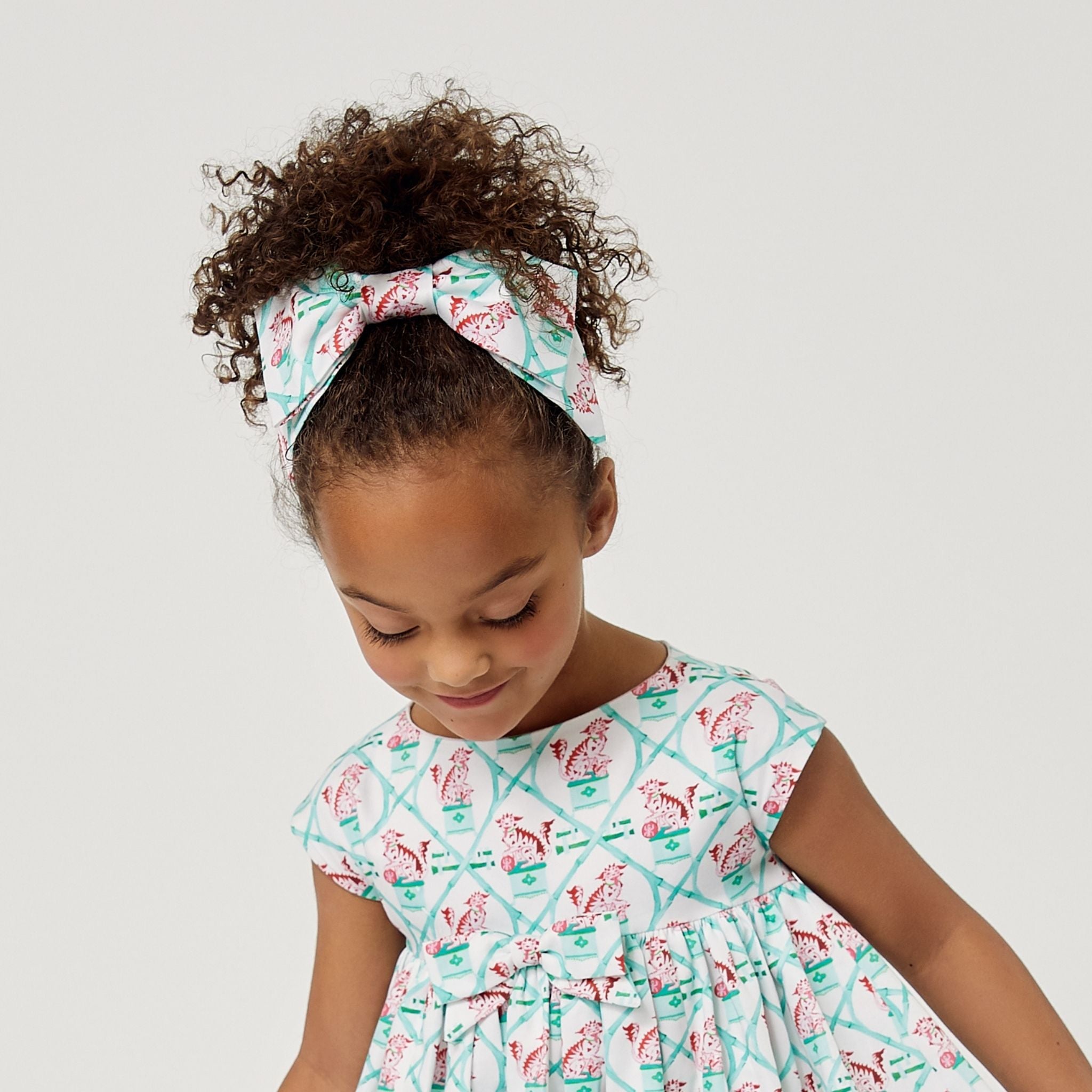 Large hair bow with Willa Heart carrot and dot print, 7 inches wide, attached to a secure 3-inch alligator clip.