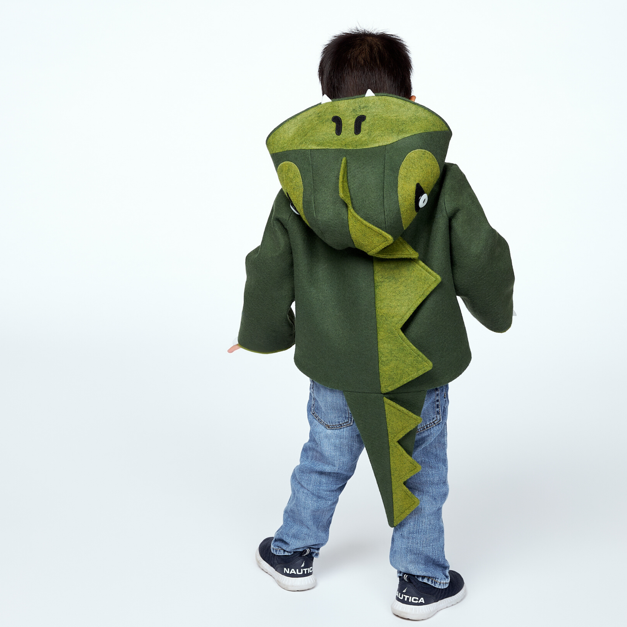 Back view of the Little Goodall Cheeky Green Dinosaur Coat, featuring a ridged hood, plush-lined tail, and soft wool-felt fabric for a fun, cozy fit.