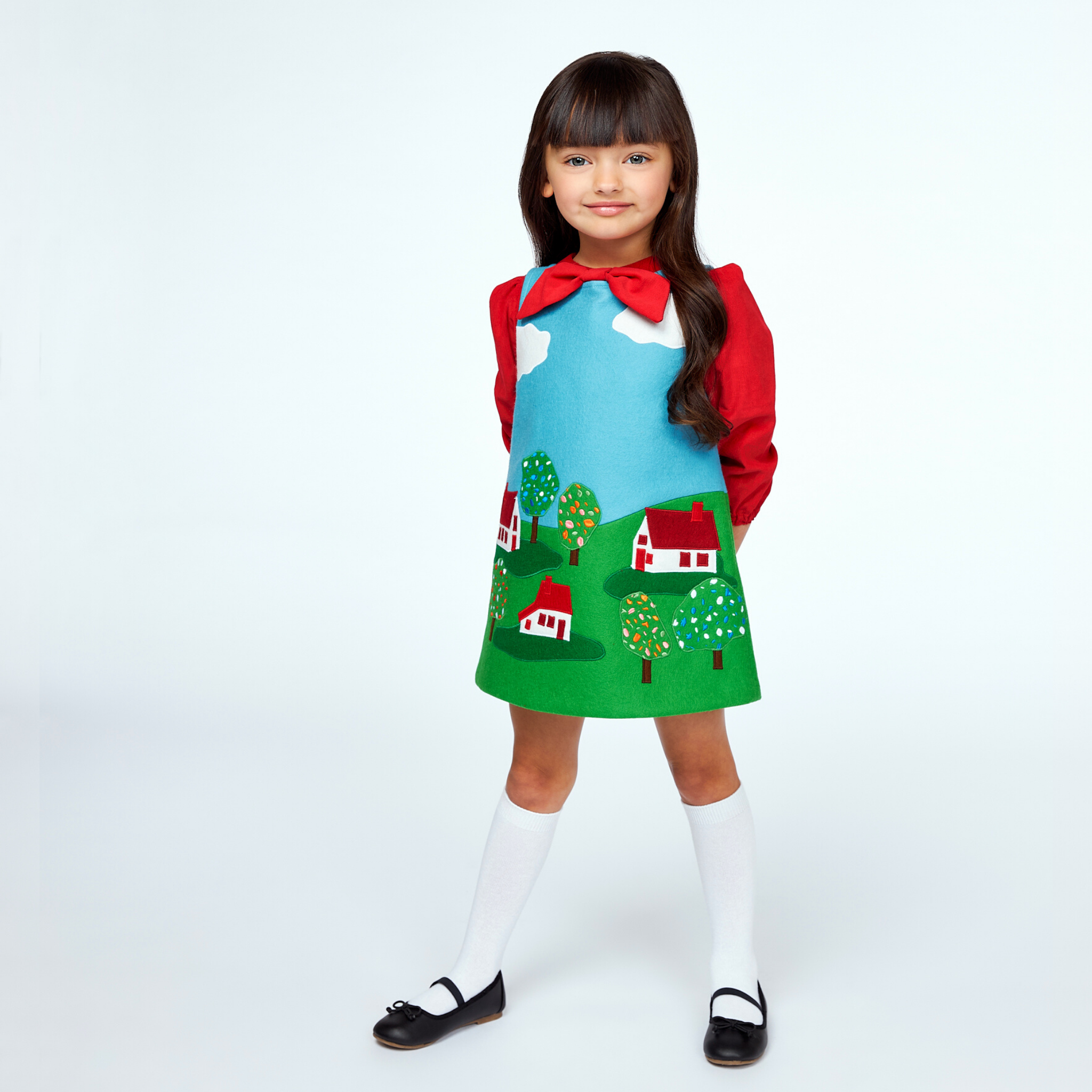 Classic children’s dress with a fairy tale village motif