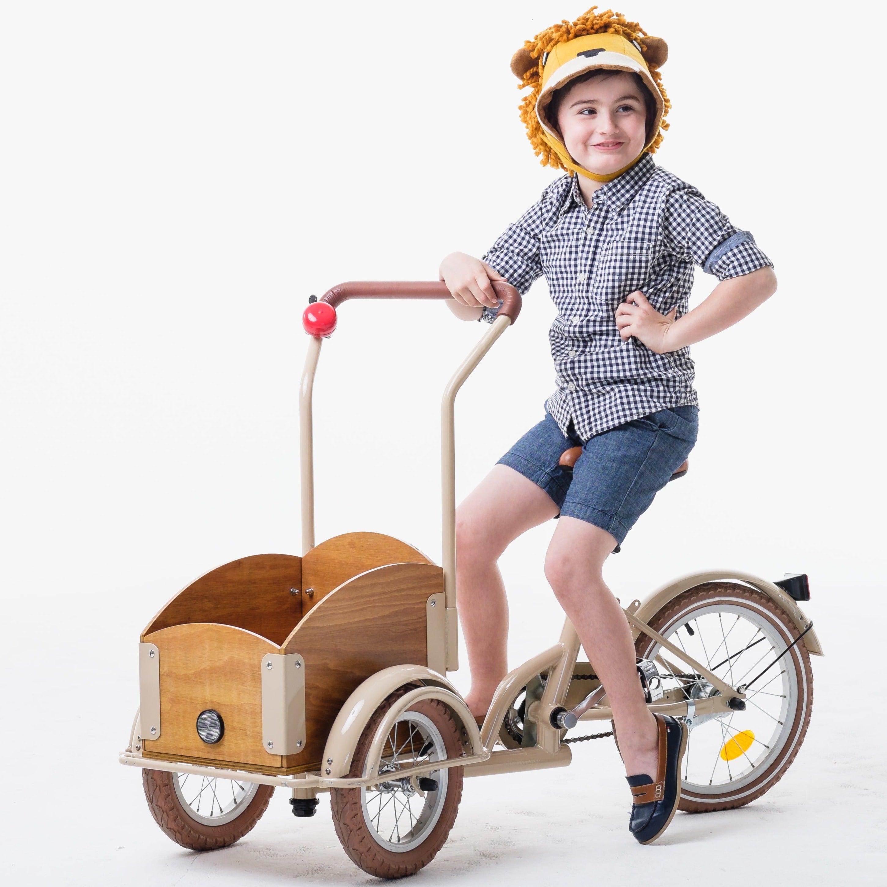 Child wearing a Ferocious Felt Lion Hat while riding a tricycle, showcasing the cozy wool blend and fun design.