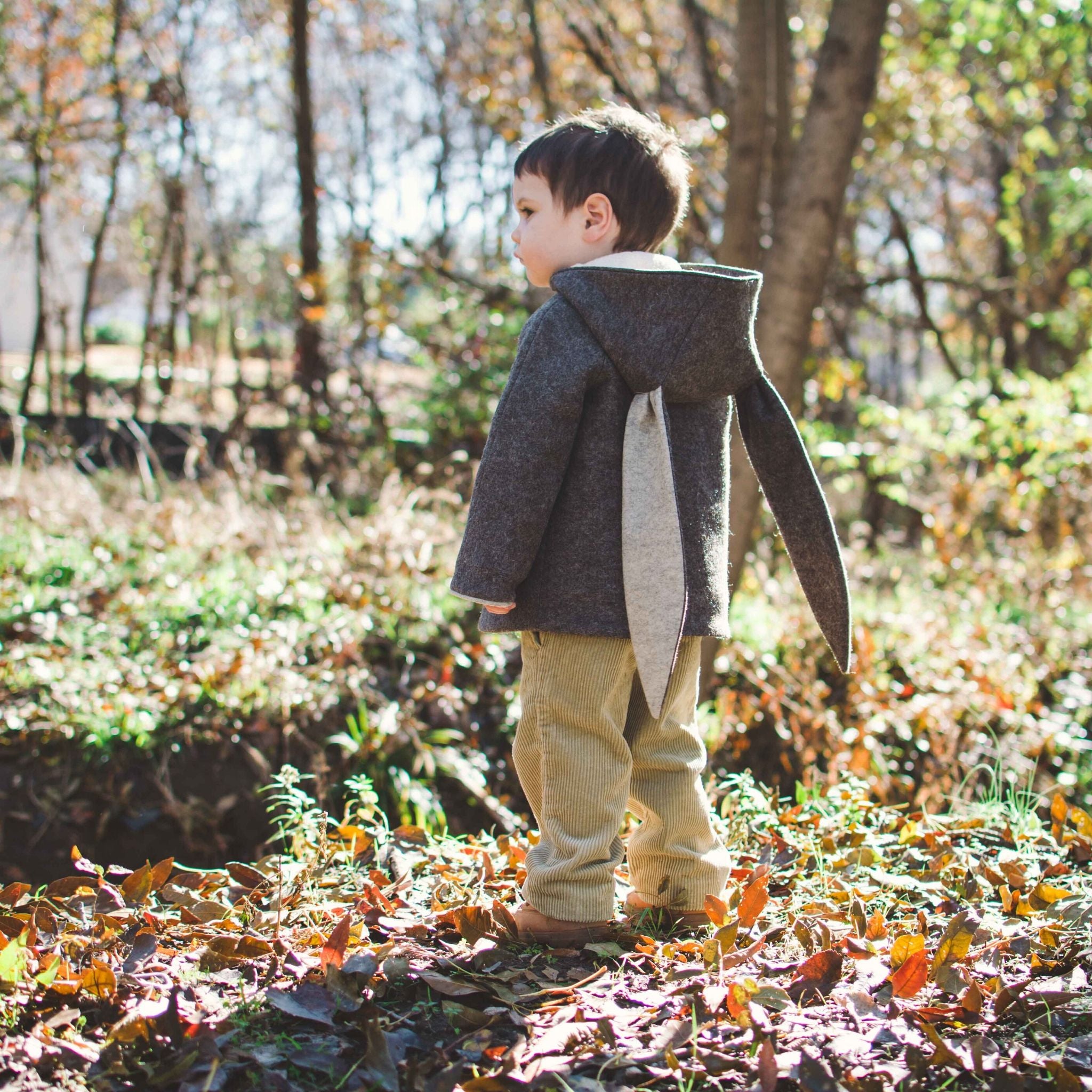 Child wearing the Little Goodall Flopsy Bunny coat, showing back view with long bunny ears and cozy wool blend fabric for cool weather