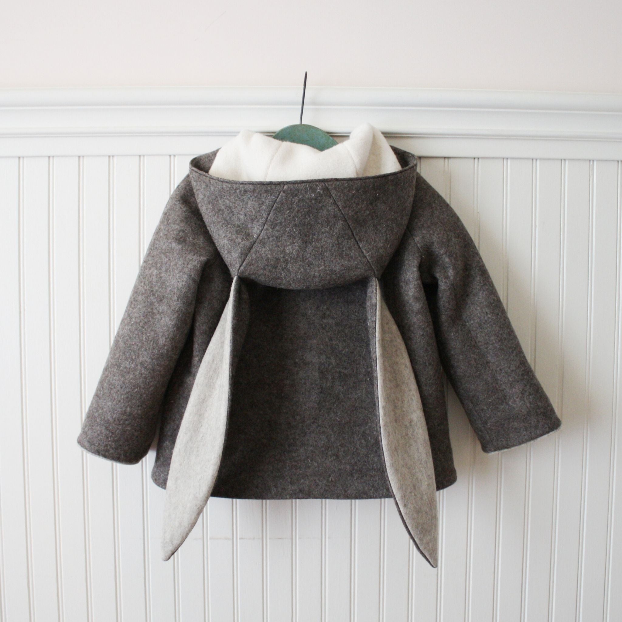 Back view of Little Goodall Flopsy Bunny coat, showing soft wool fabric, plush lining, and long bunny ear hood.