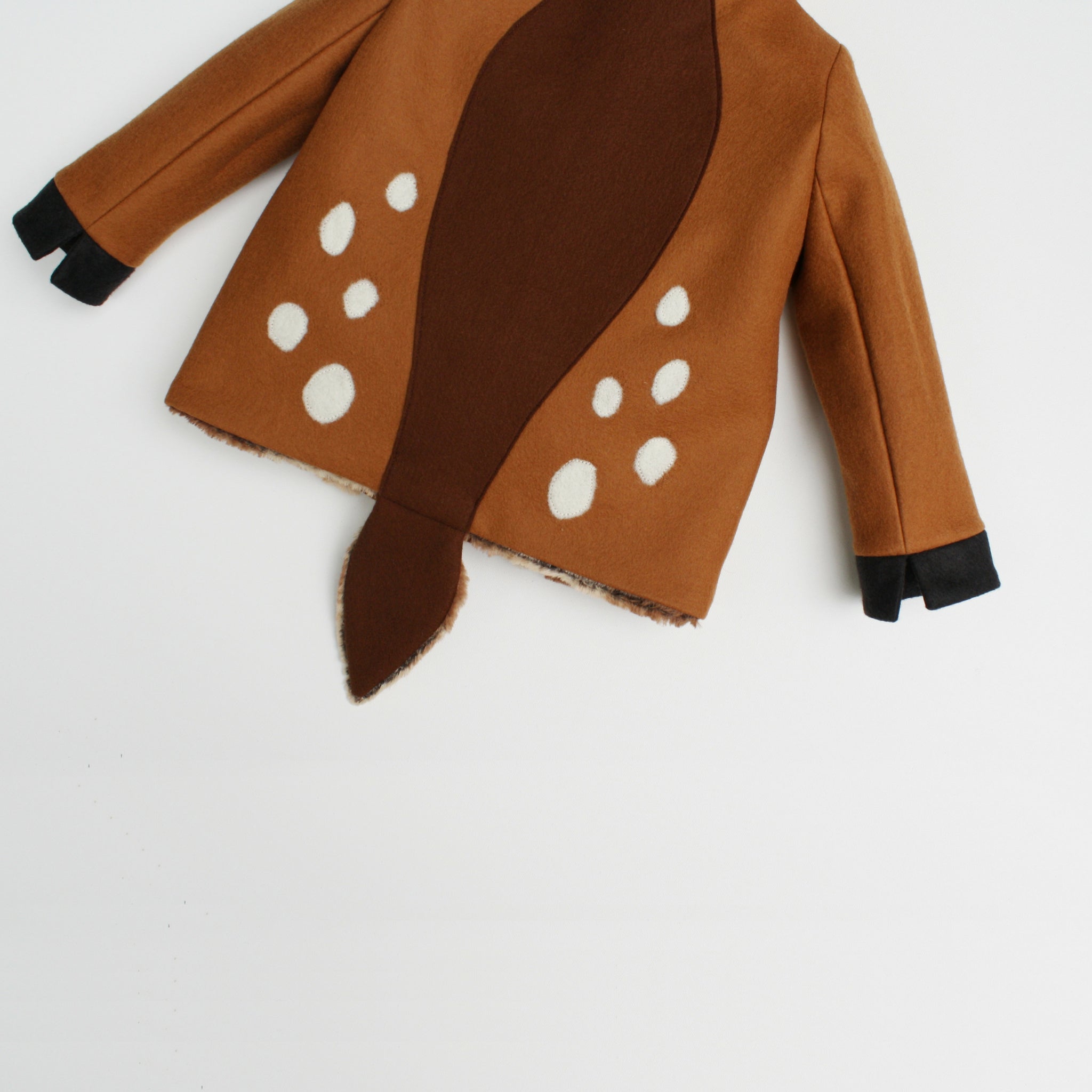 Back view of the Little Goodall Frolicsome Fawn Coat, featuring a soft brown tail, white wool spots, and black cuff details