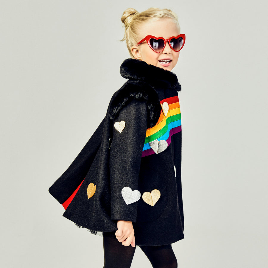 Girls' black wool coat with rainbow appliqué, gold and silver hearts, faux fur collar, and red pleat detail