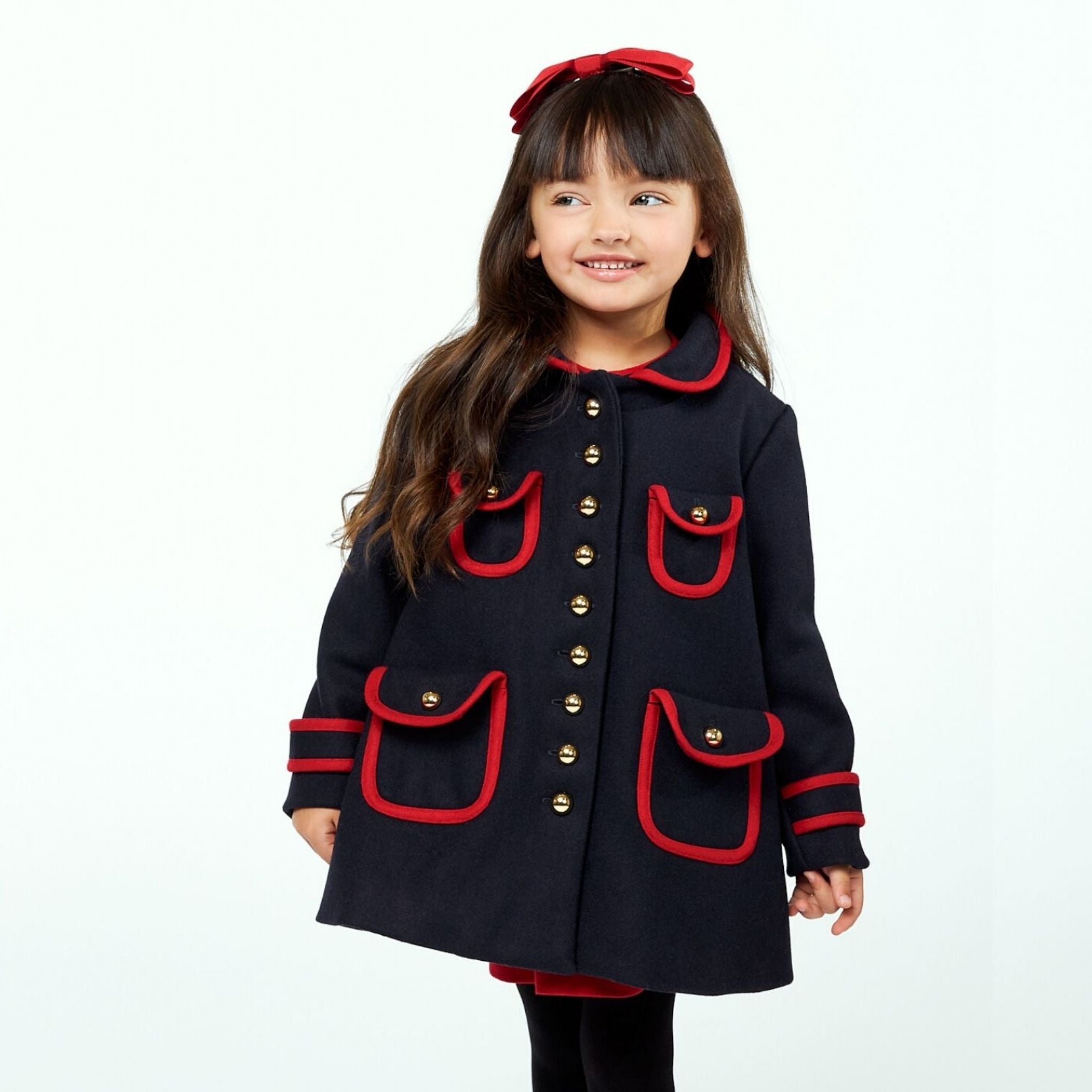 Dark blue wool winter coat with red trim, gold buttons, and A-line fit. Stylish and warm for cold weather.
