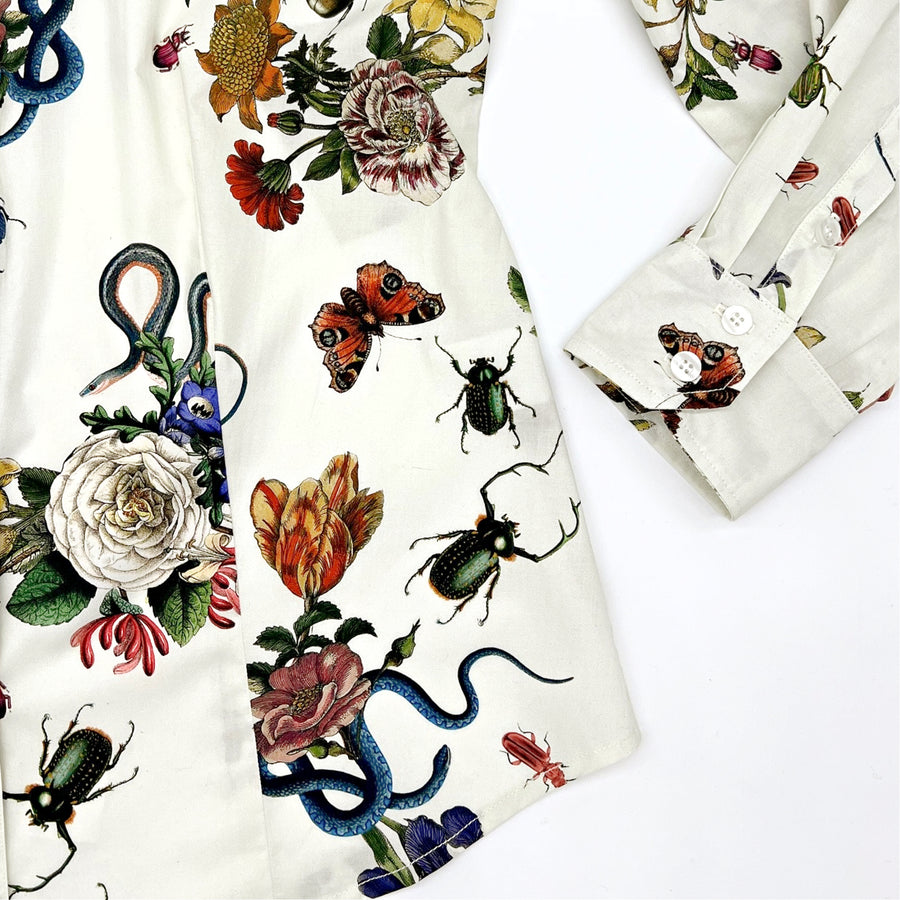 Close-up of Little Goodall ivory botanical print shirt, showing sleeve cuff and floral details