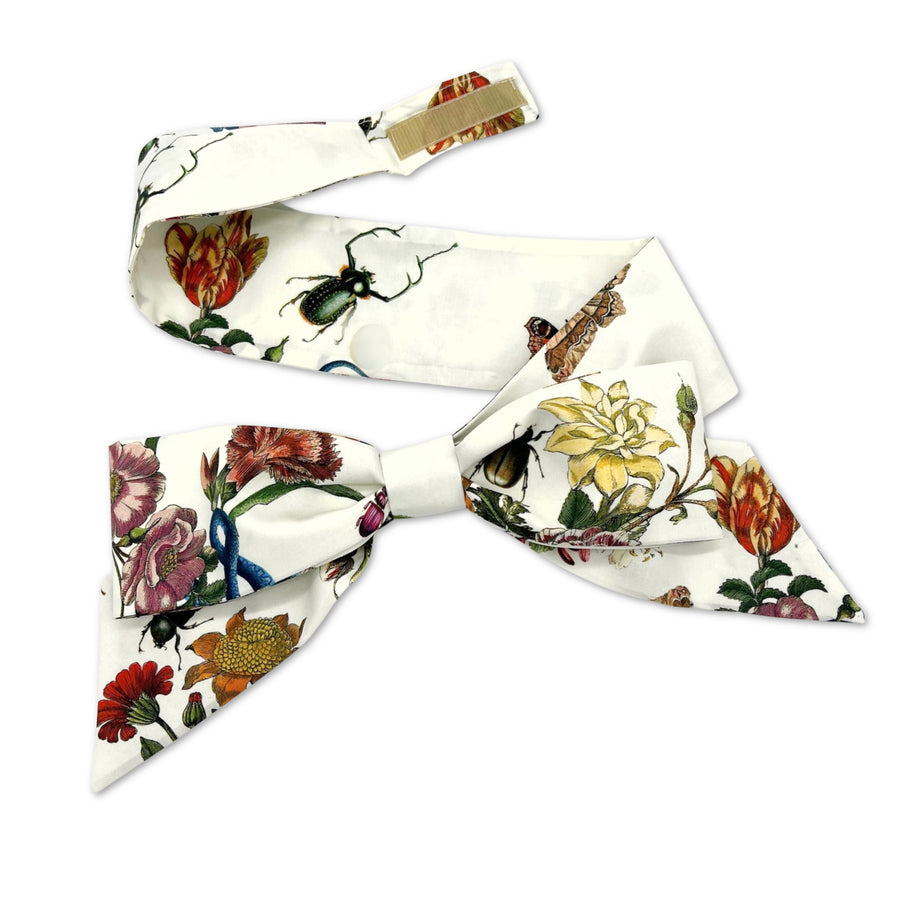 Removable ivory botanical bow hatband with floral print and visible Velcro closure